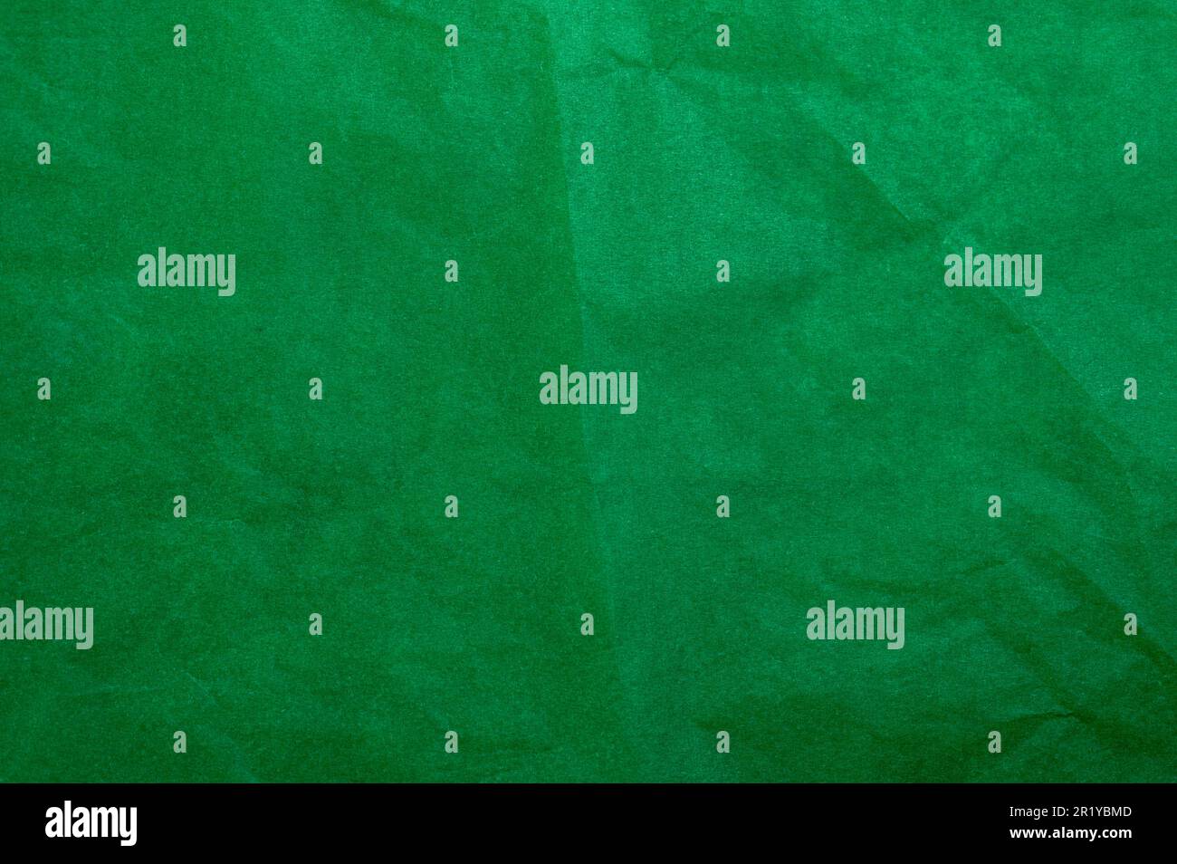 Crumpled dark green tracing paper as texture, holiday backdrop or