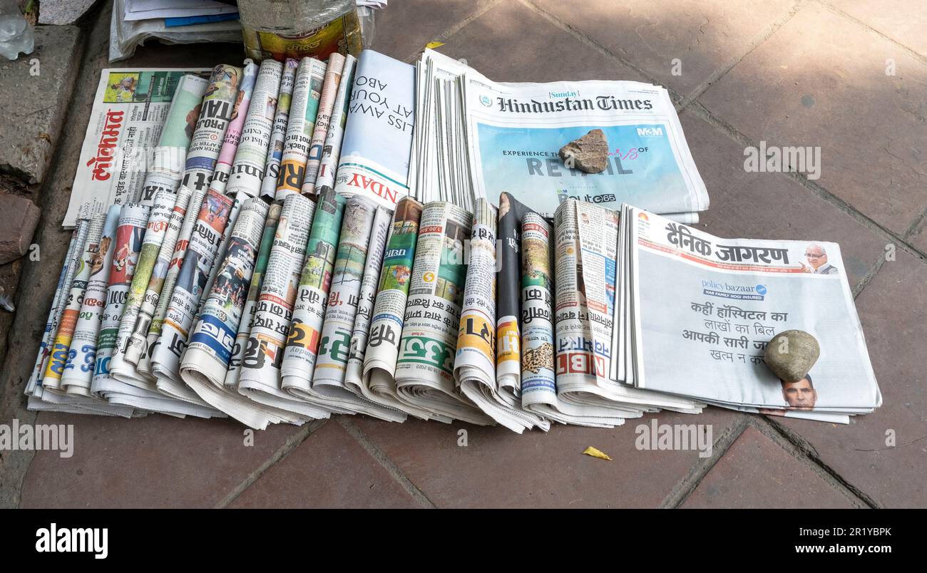 NEW - DELHI SEPT 18: Rows of Indian media newspapers and magazines on a sidewalk in New Delhi on September 18. 2022 in India Stock Photo