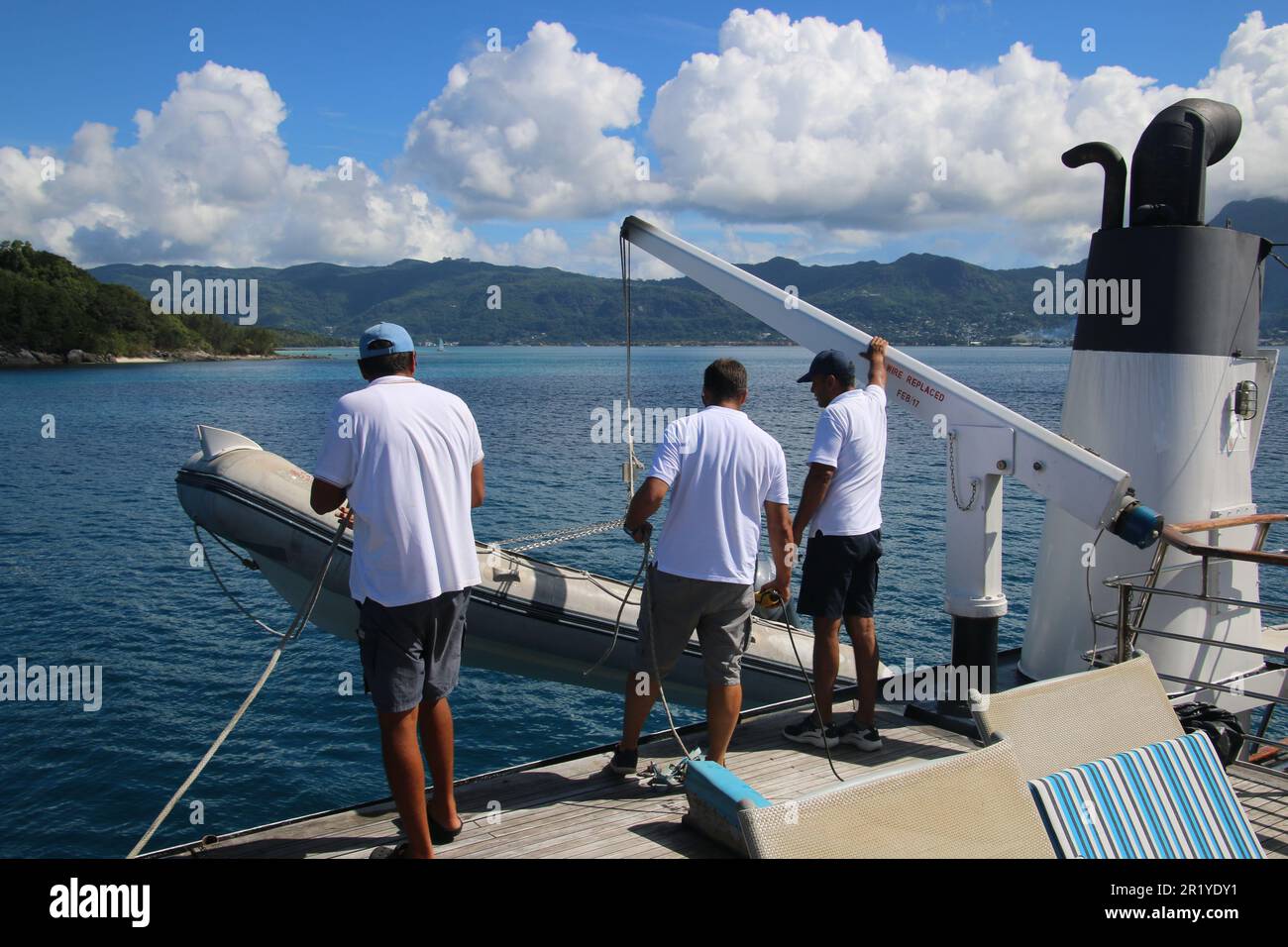 Rubber Dinghy lifeboat with passengers wearing orange life jackets