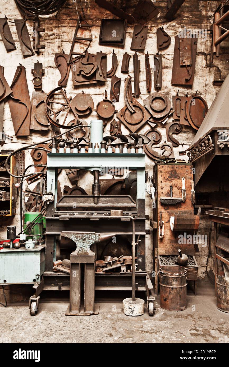 Workshop, metal tools and forge with wall background for industry