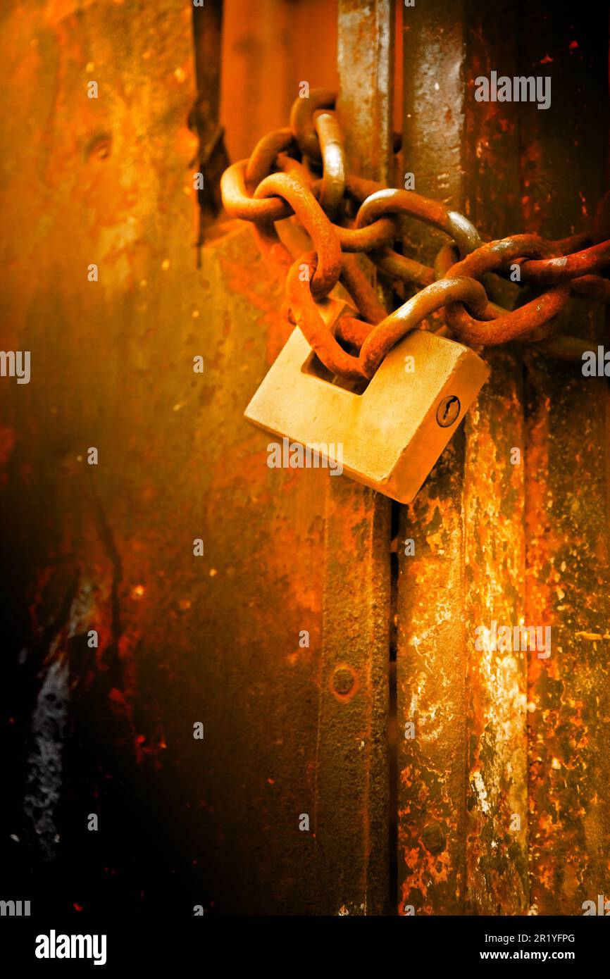 Rusty metal gate closed with padlock - concept image Stock Photo