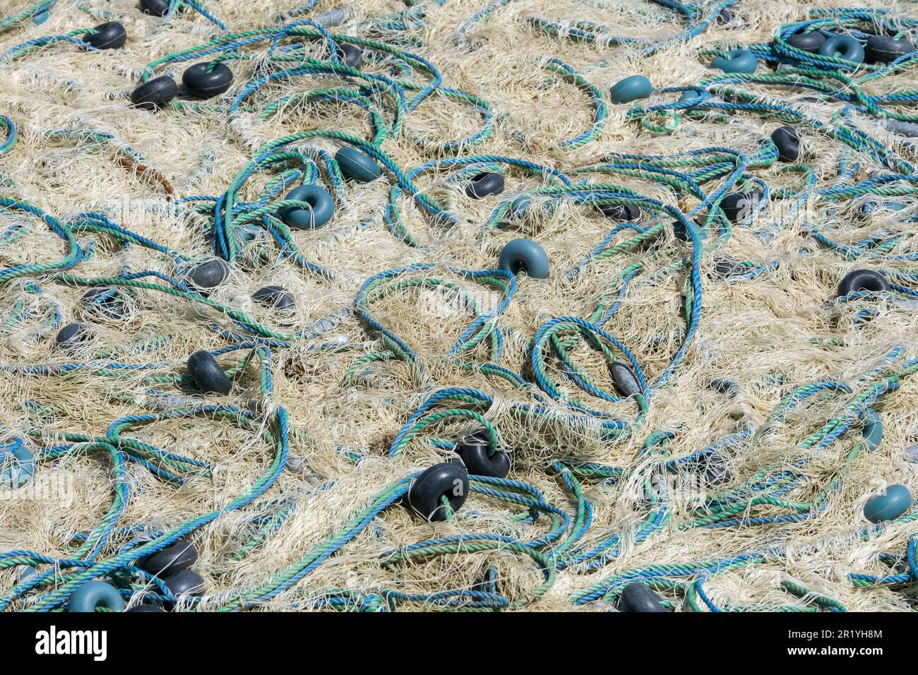 https://c8.alamy.com/comp/2R1YH8M/mixture-of-colorful-fishing-nets-floats-and-ropes-fisherman-material-background-2R1YH8M.jpg