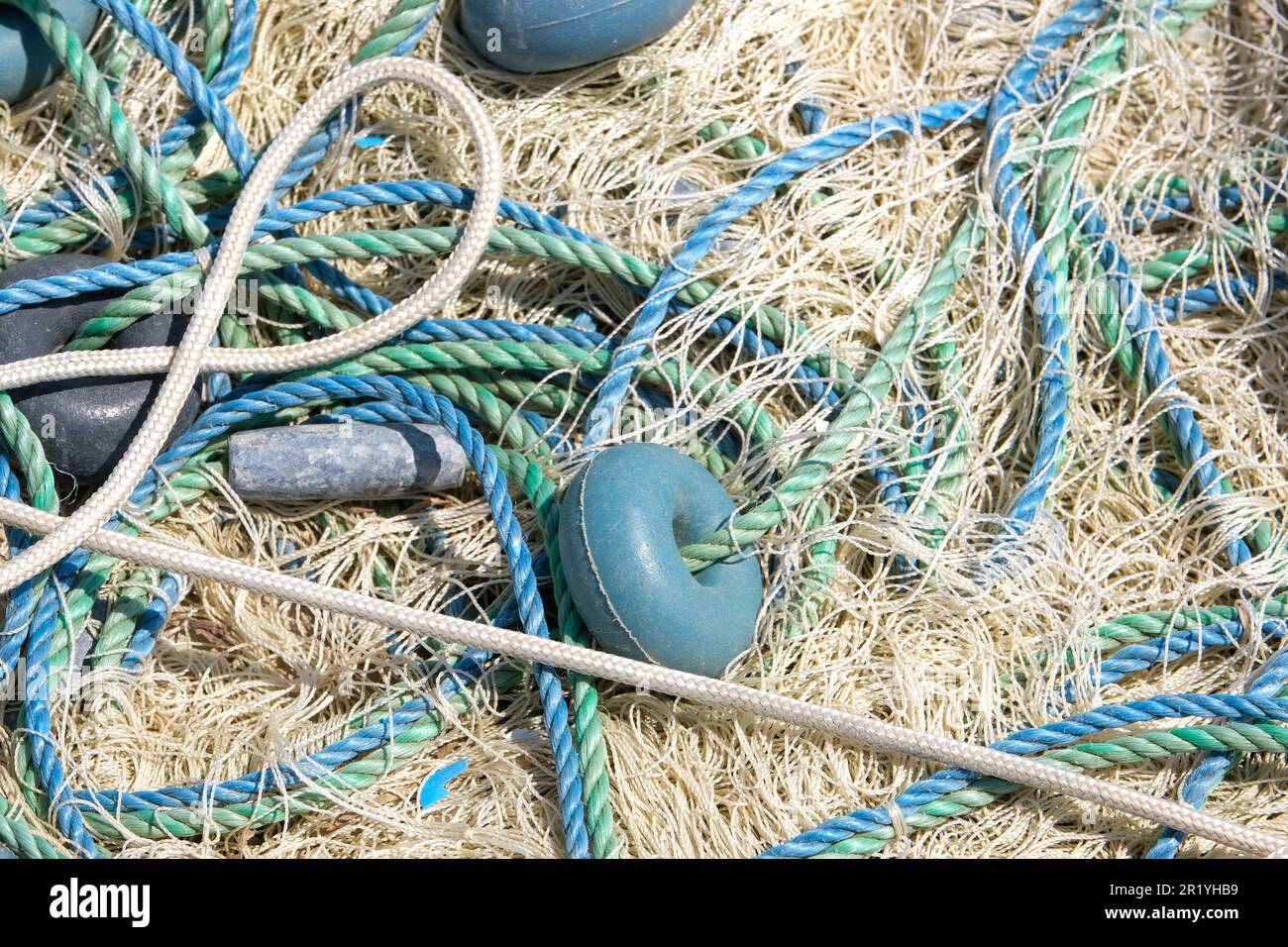 https://c8.alamy.com/comp/2R1YHB9/mixture-of-colorful-fishing-nets-floats-and-ropes-fisherman-material-background-2R1YHB9.jpg