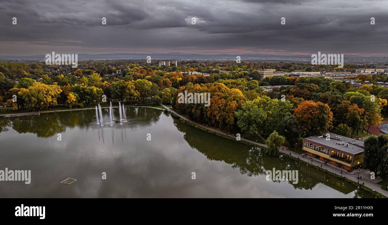 Drone view, aerial, landscape with lake (pond, lagoon), fountains and clouds - Zalew Nowohucki, Kraków Cracow, Poland, Europe, water reservoir, Stock Photo