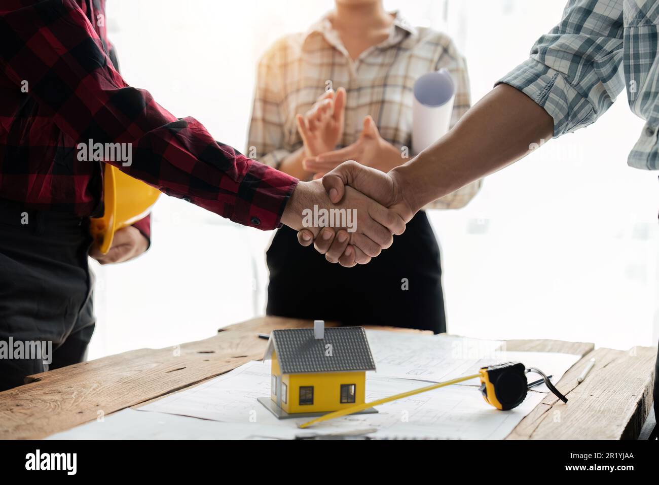 Close up view of engineering team shaking hands after the deal is ...