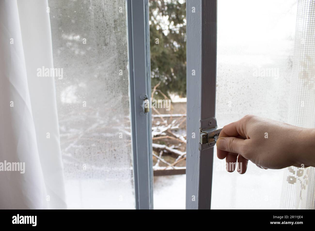 The misty window that opens into the snow-covered garden. Stock Photo