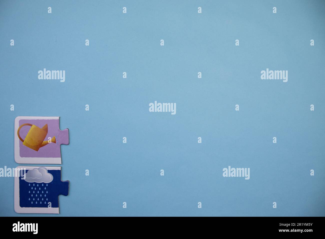 Information puzzle placed on the edge of the blue background. Rain, jug Stock Photo