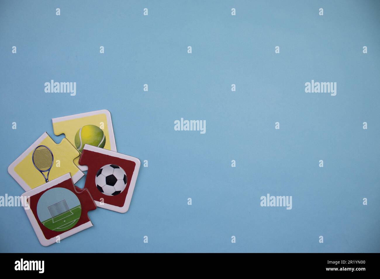 Information puzzles placed on the edge of the blue background. Tennis, football. Stock Photo