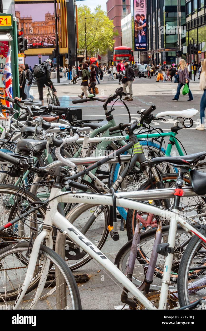 Bicycles at bike racks on the pavement on Tottenham Court Road in
