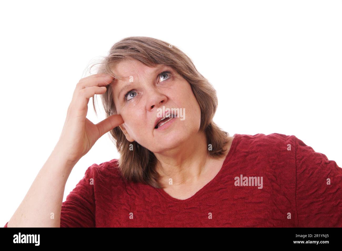 senior woman scratching her head thinking Stock Photo
