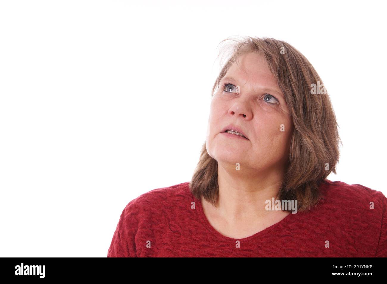 Older woman looks up and thinks Stock Photo