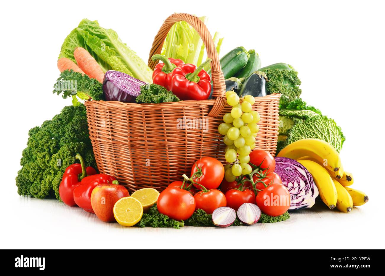 Wicker basket with assorted organic vegetables and fruits isolated on ...