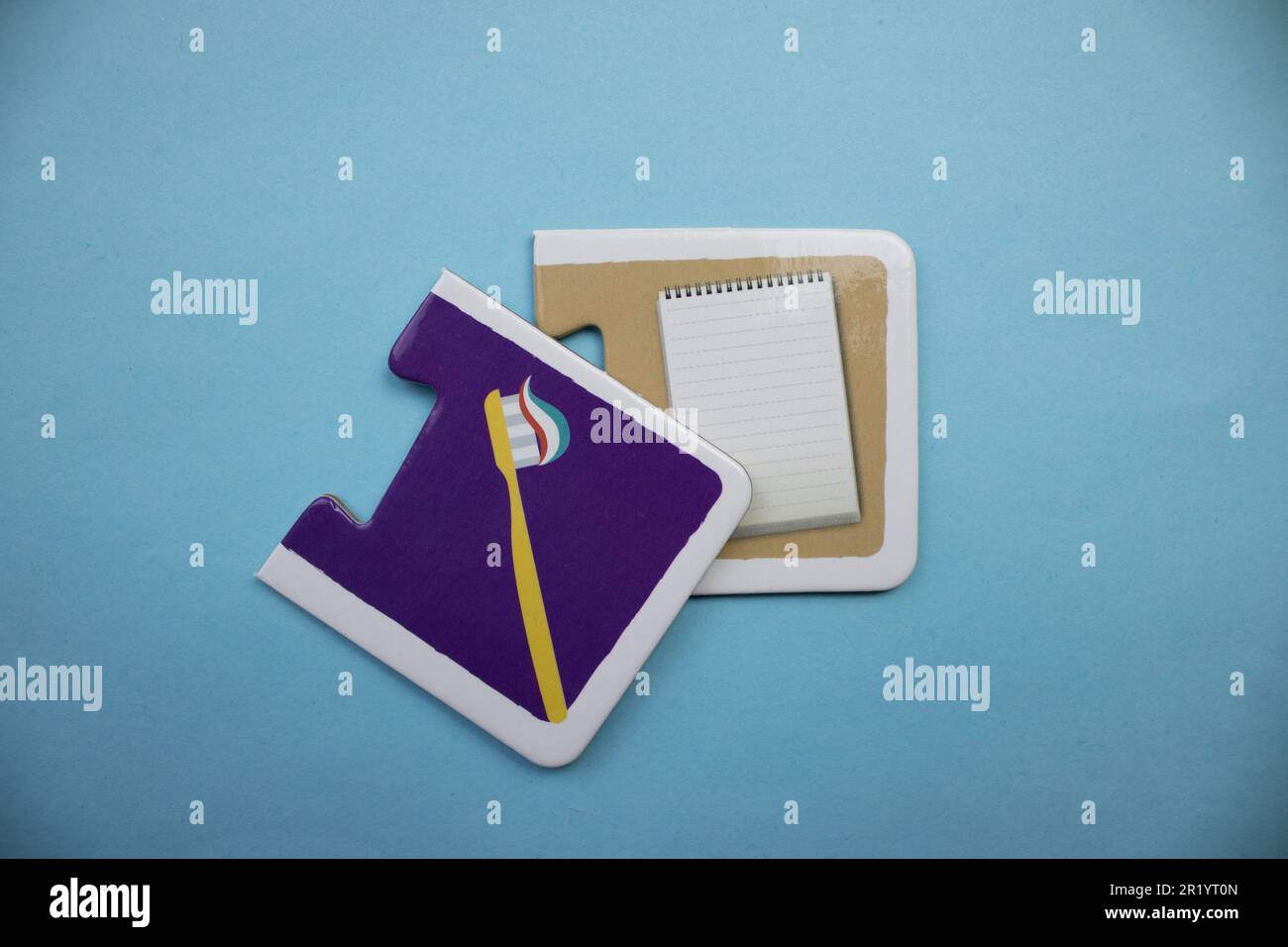 Information puzzle placed on a blue background. Toothbrush, notebook Stock Photo