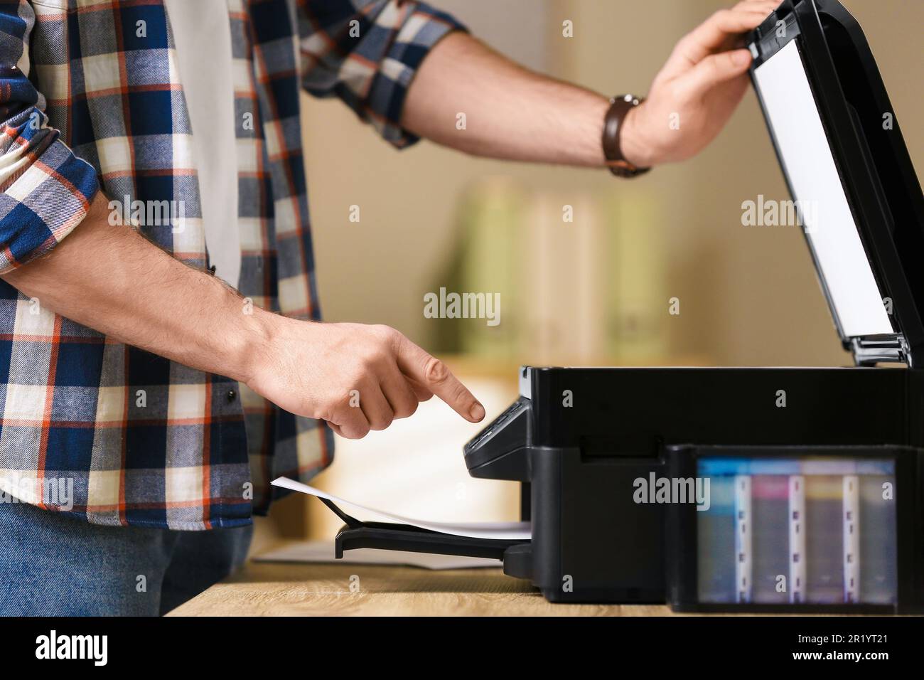 Man using modern multifunction printer in office, closeup Stock Photo ...