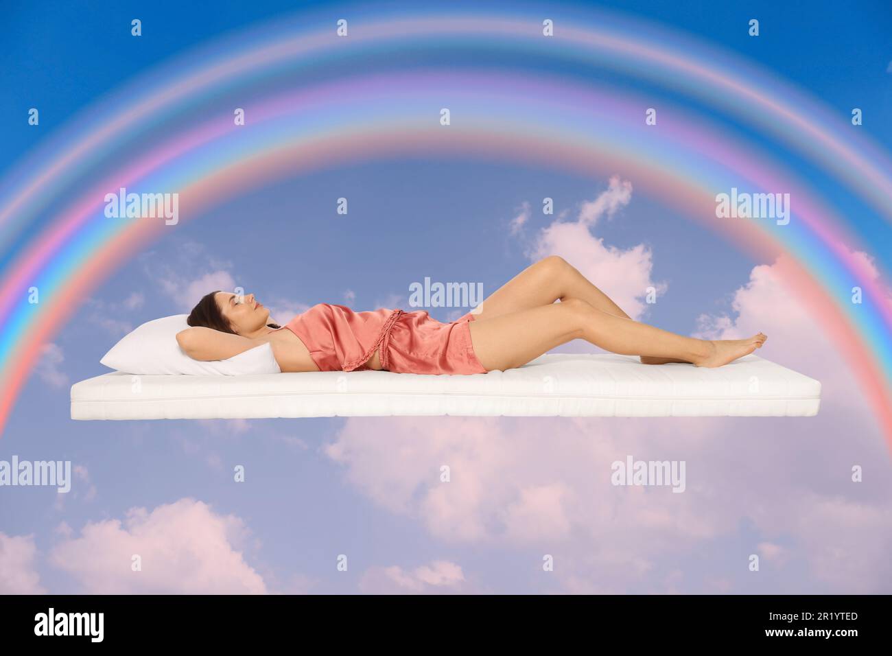 Sweet dreams. Young woman lying on mattress in blue sky with bright ...
