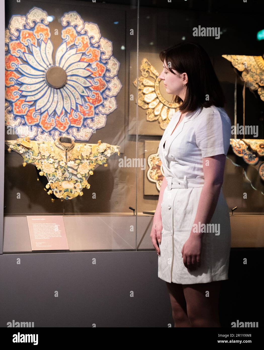 A British Museum worker looks at detachable collars during a photo call
