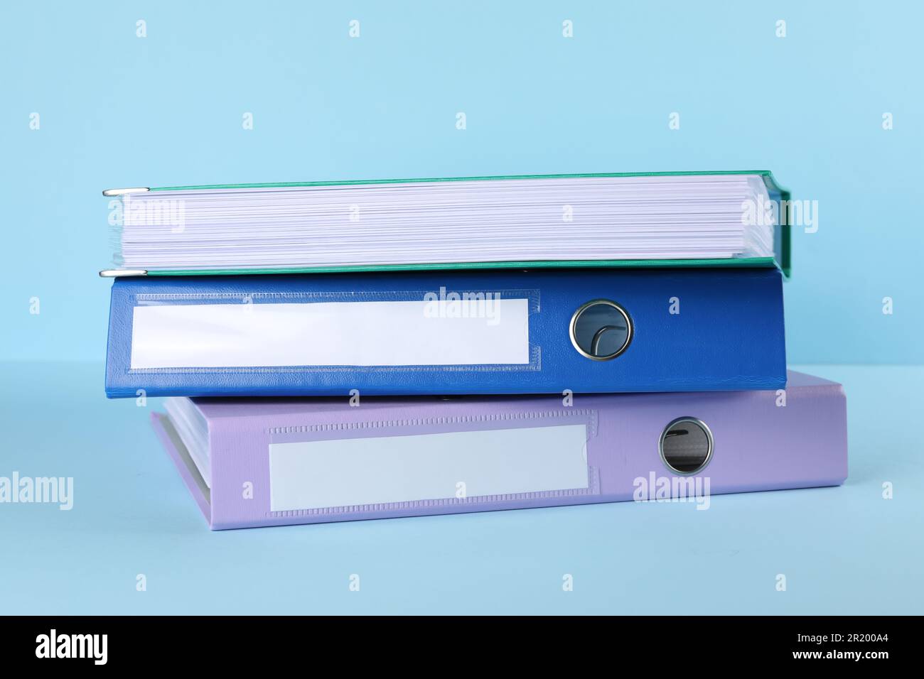 Stack of office folders on light blue background Stock Photo
