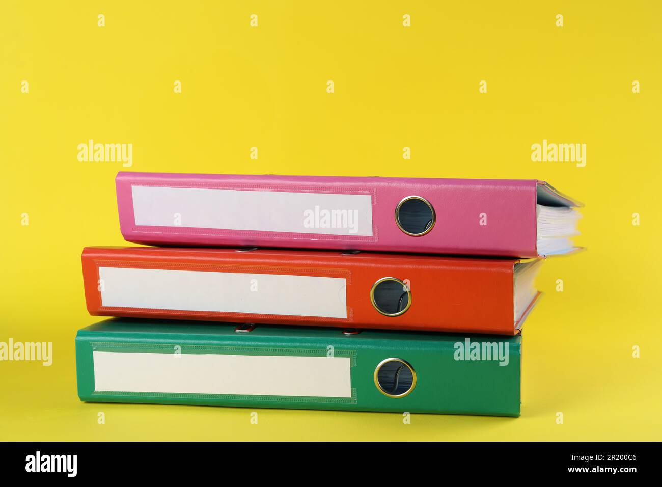 Stack of office folders on yellow background Stock Photo - Alamy