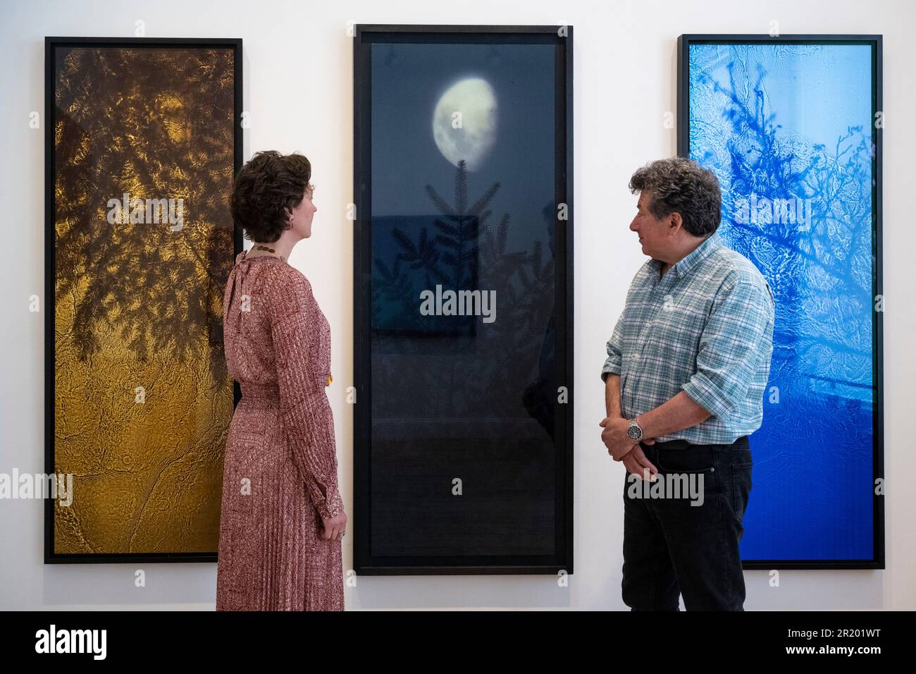 London, UK.  16 May 2023.  Ex-Director of Impressionist and Modern Art at Sotheby’s, Sophie Camu Lindsay and her husband and photographer, Alexander Lindsay, with 'River Taw The Streens, Gold Fir', 1998-2020, 'Half Moon Fir', 2003, and 'The Streens, Alder', 1998-2019 all by Susan Derges, at their first ‘Space to Breathe’ exhibition.  Works by four British artists are on show at Cromwell Place in South Kensington ahead of the main exhibition and festival, at Bowhouse, in the East Neuk of Fife, Scotland 15 July to 6 August 2023.    Credit: Stephen Chung / Alamy Live News Stock Photo