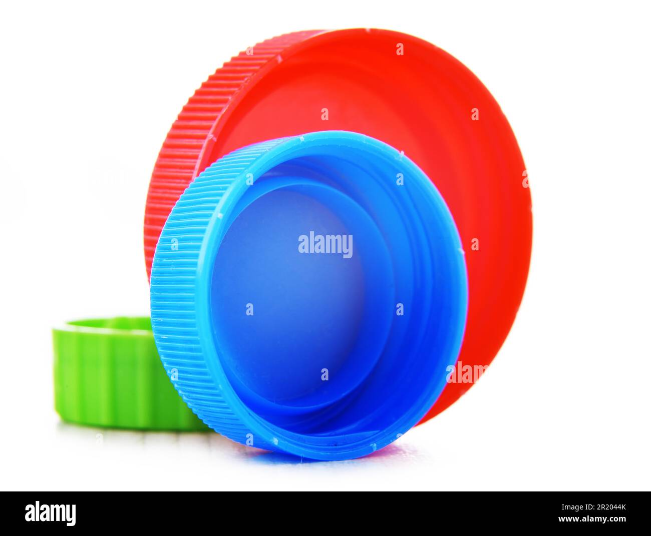 Colorful plastic bottle caps isolated on white. Recycling Stock Photo