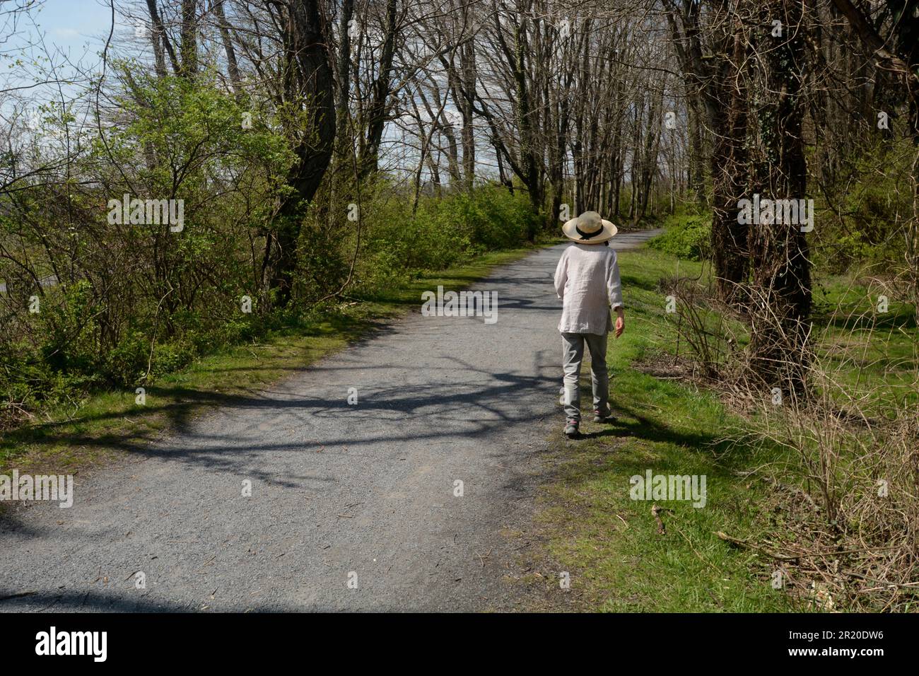 A woman walks along along the Virginia Creeper Trail in Abingdon, Virginia. Stock Photo