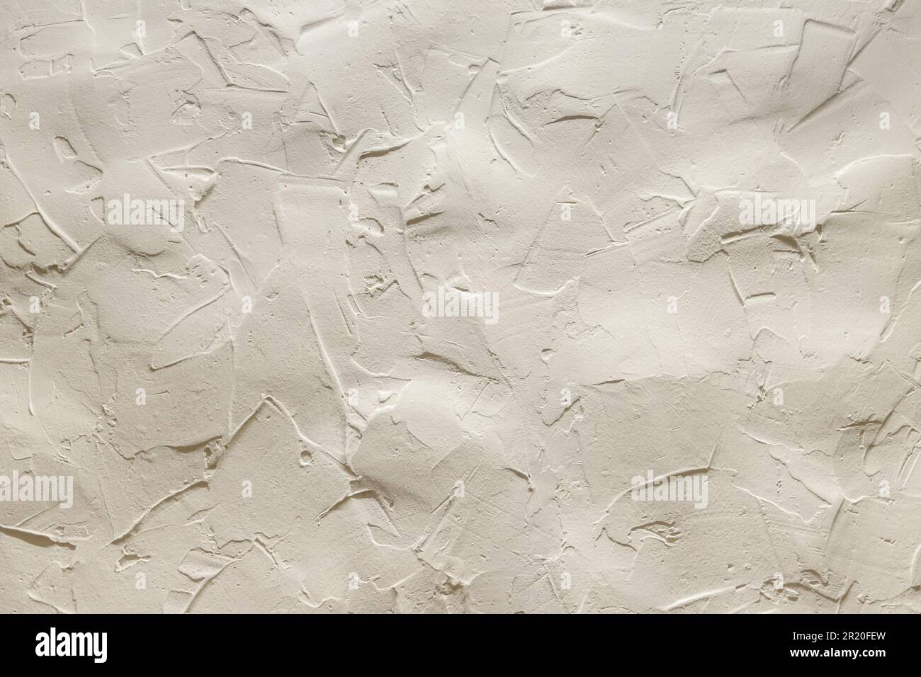 The uneven surface of a beige clay wall Stock Photo - Alamy