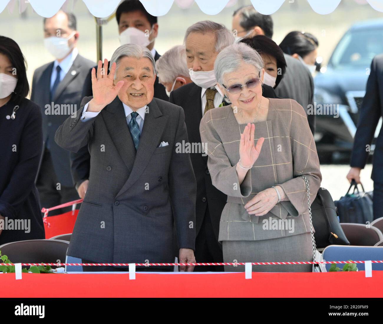 Former Japanese Emperor Akihito and former Empress Michiko wave their