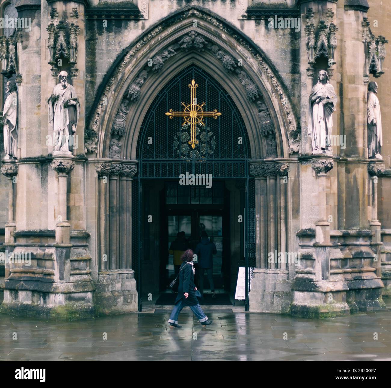 The people walking against the facade of a church on a rainy day Stock ...