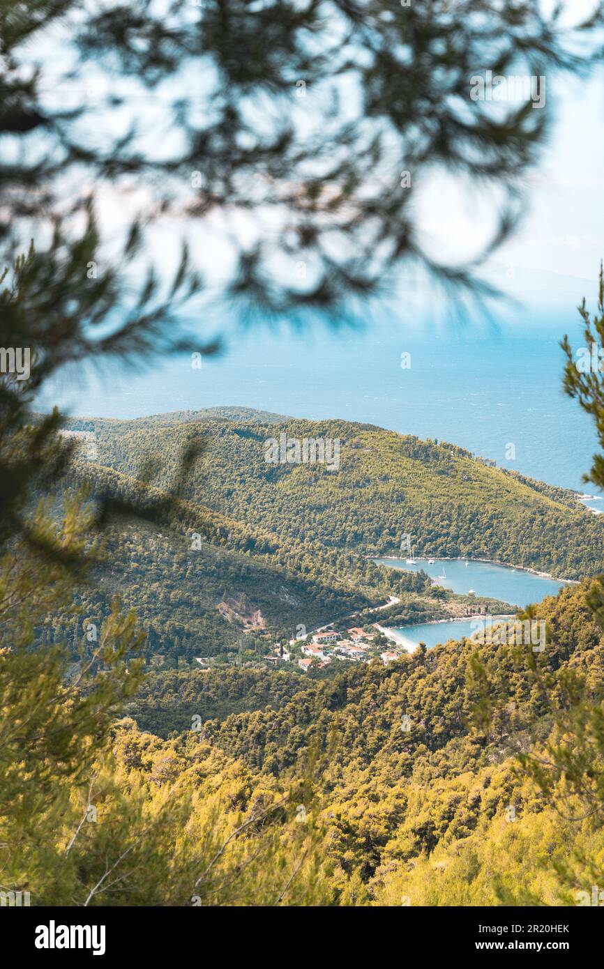An idyllic rural landscape featuring a small village situated among a ...