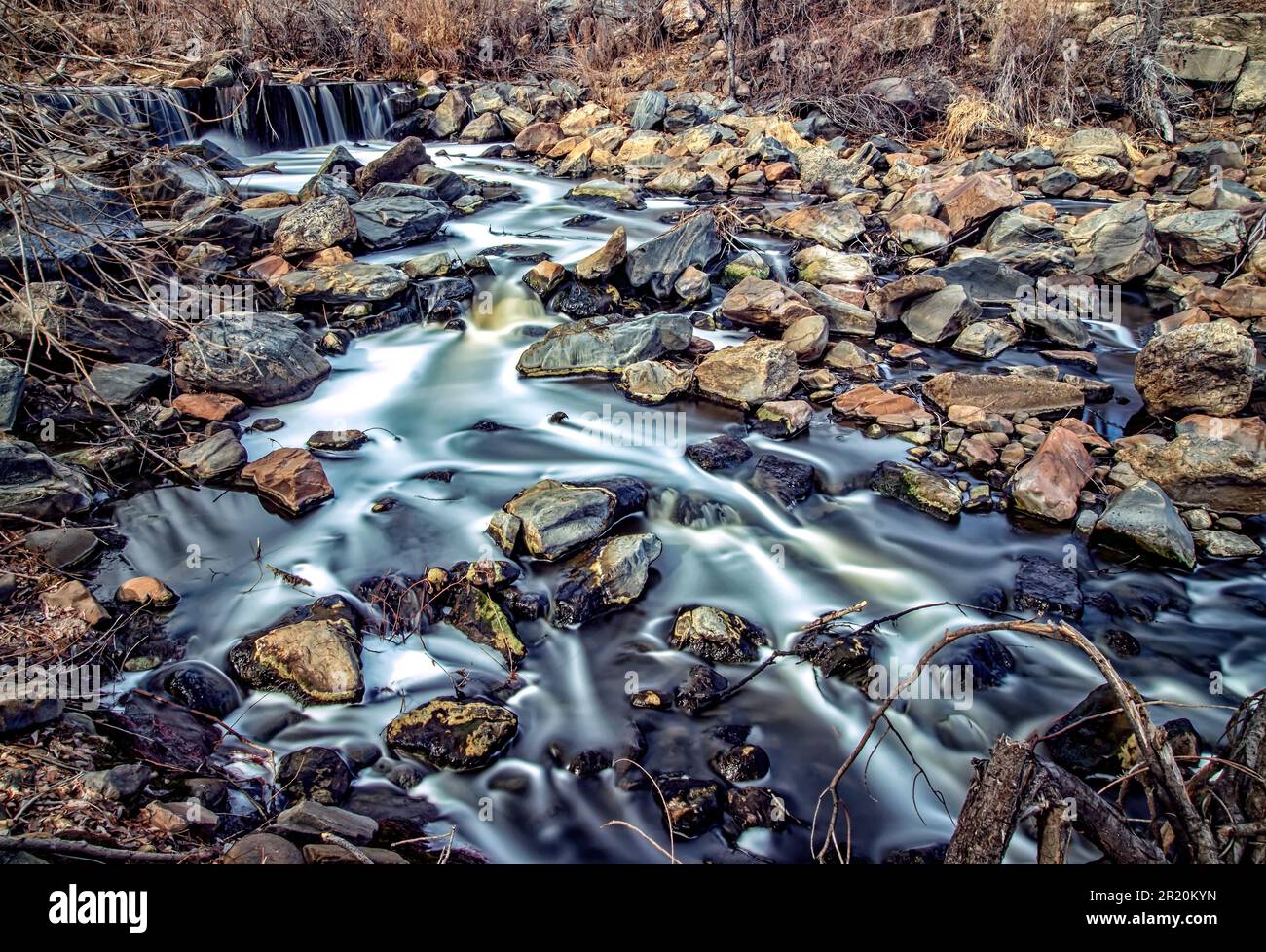 A long exposure of a river flowing through rocks Stock Photo - Alamy