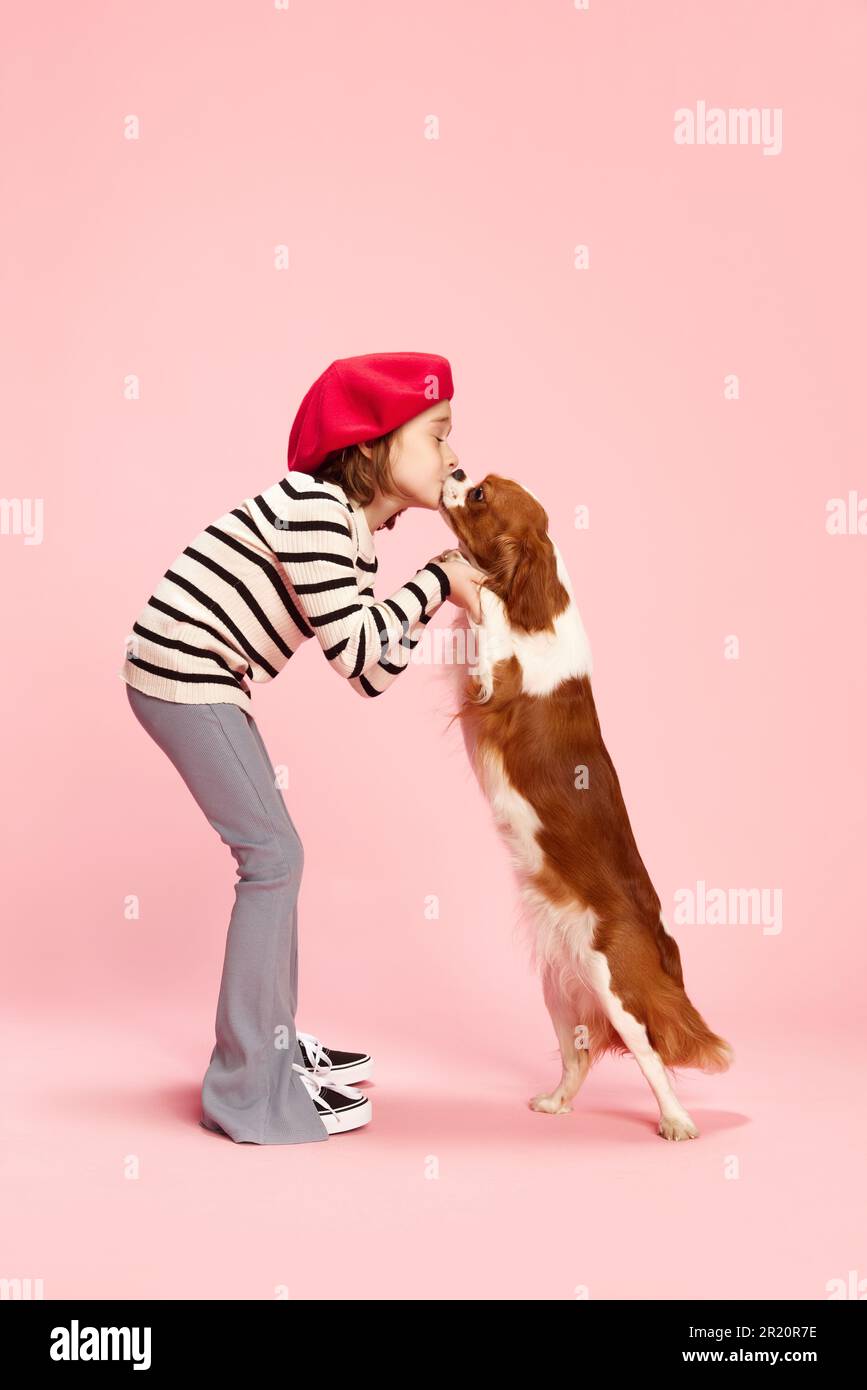 Premium Photo  A little girl kisses and hugs her jack russell terrier dog  in the park love between the owner and the dog a child is holding a dog in  his