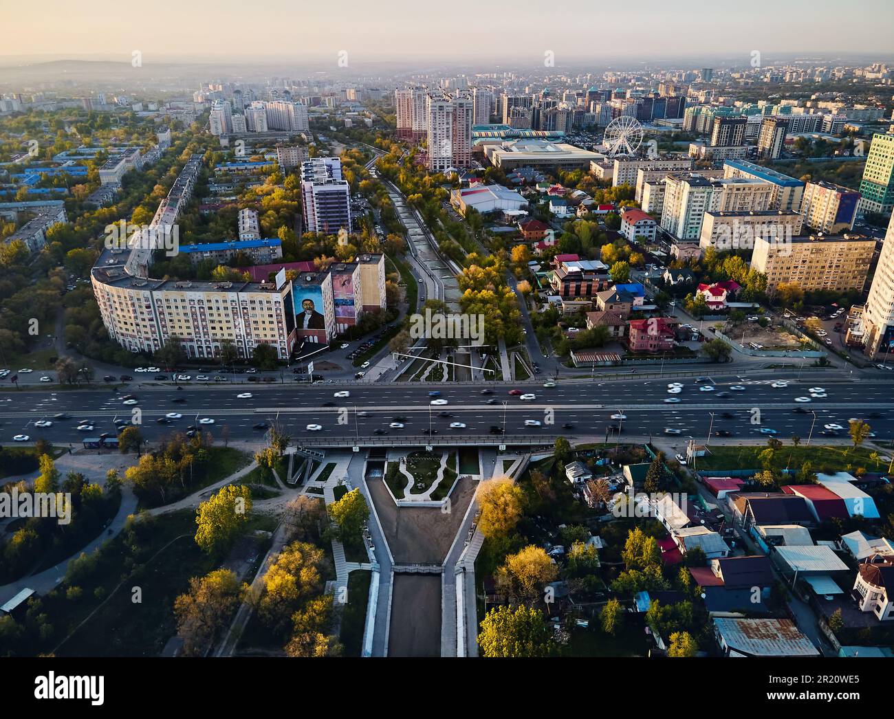 Aerial drone view panorama of big Almaty river and road alfarabi with cars and buildings around in Almaty city, Kazakhstan Stock Photo