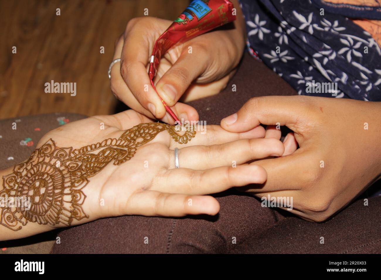 Young Teen Age Indian Girl painting henna Tattoo on the hand Stock ...