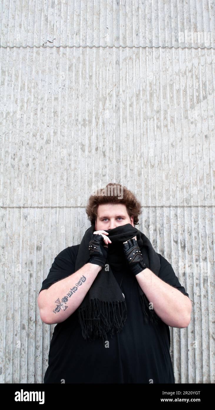 https://c8.alamy.com/comp/2R20YGT/the-influencer-drachenlord-with-a-dark-beard-wearing-a-black-shirt-and-black-leather-gloves-in-front-of-a-wall-2R20YGT.jpg