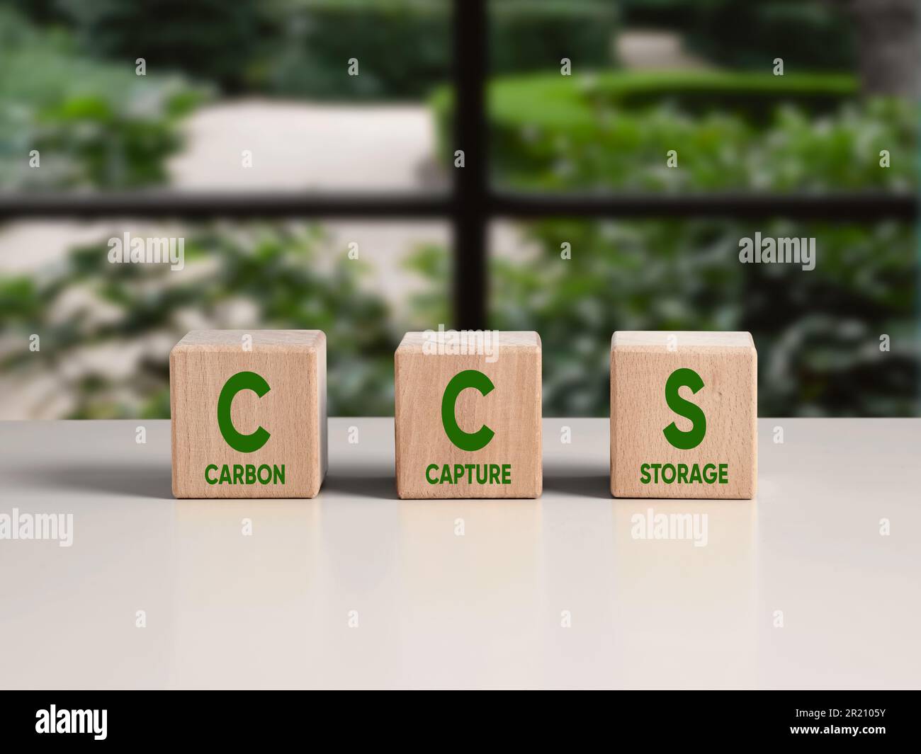 The words Carbon Capture Storage and acronym CCS on wooden cubes. Environmental protection and net zero concept. Green energy, reduce carbon footprint Stock Photo