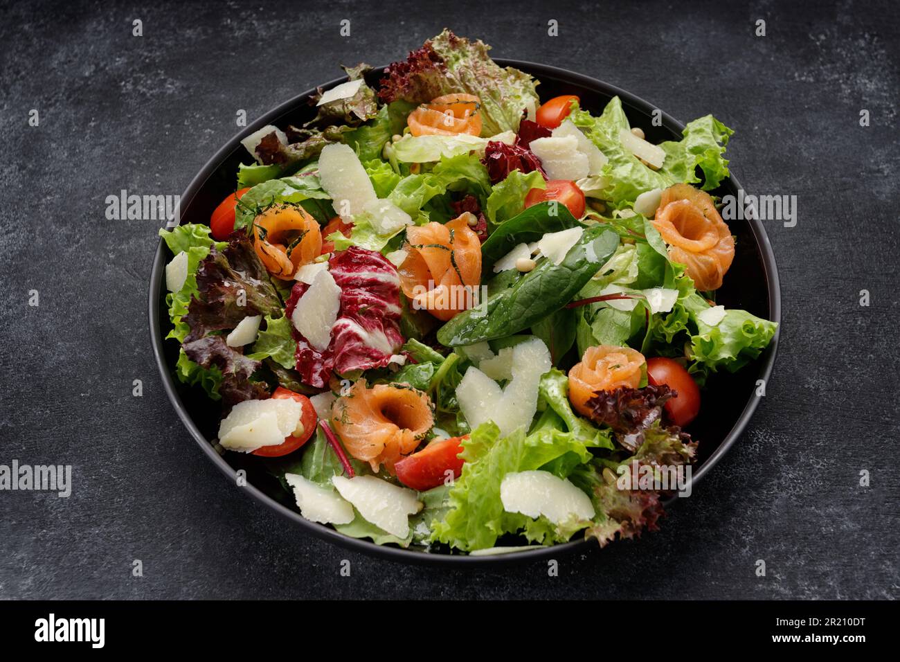 https://c8.alamy.com/comp/2R210DT/deliciously-crafted-salad-with-salmon-parmesan-tomatoes-and-mixed-greens-2R210DT.jpg