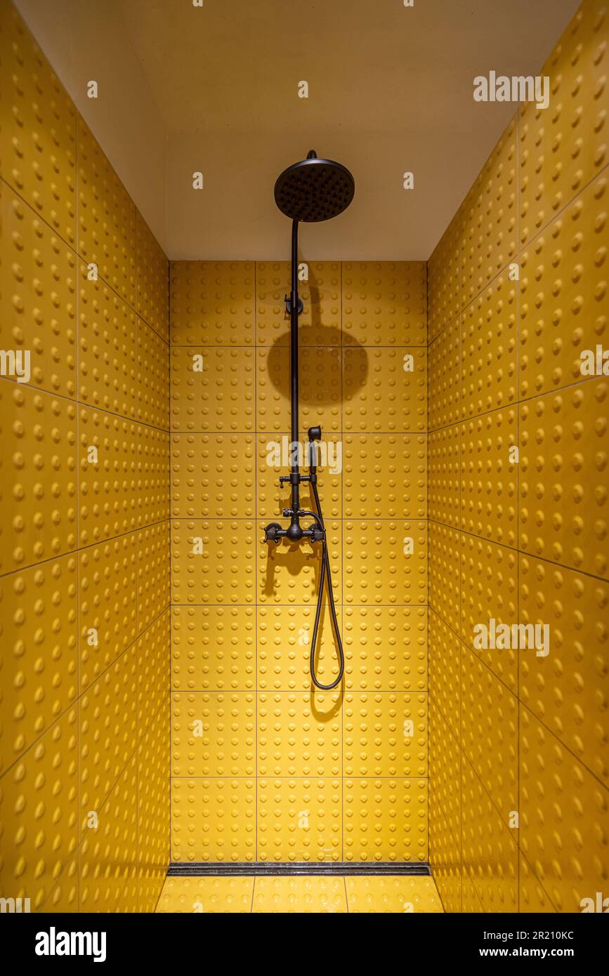 Shower cabin made with yellow tiles Stock Photo Alamy