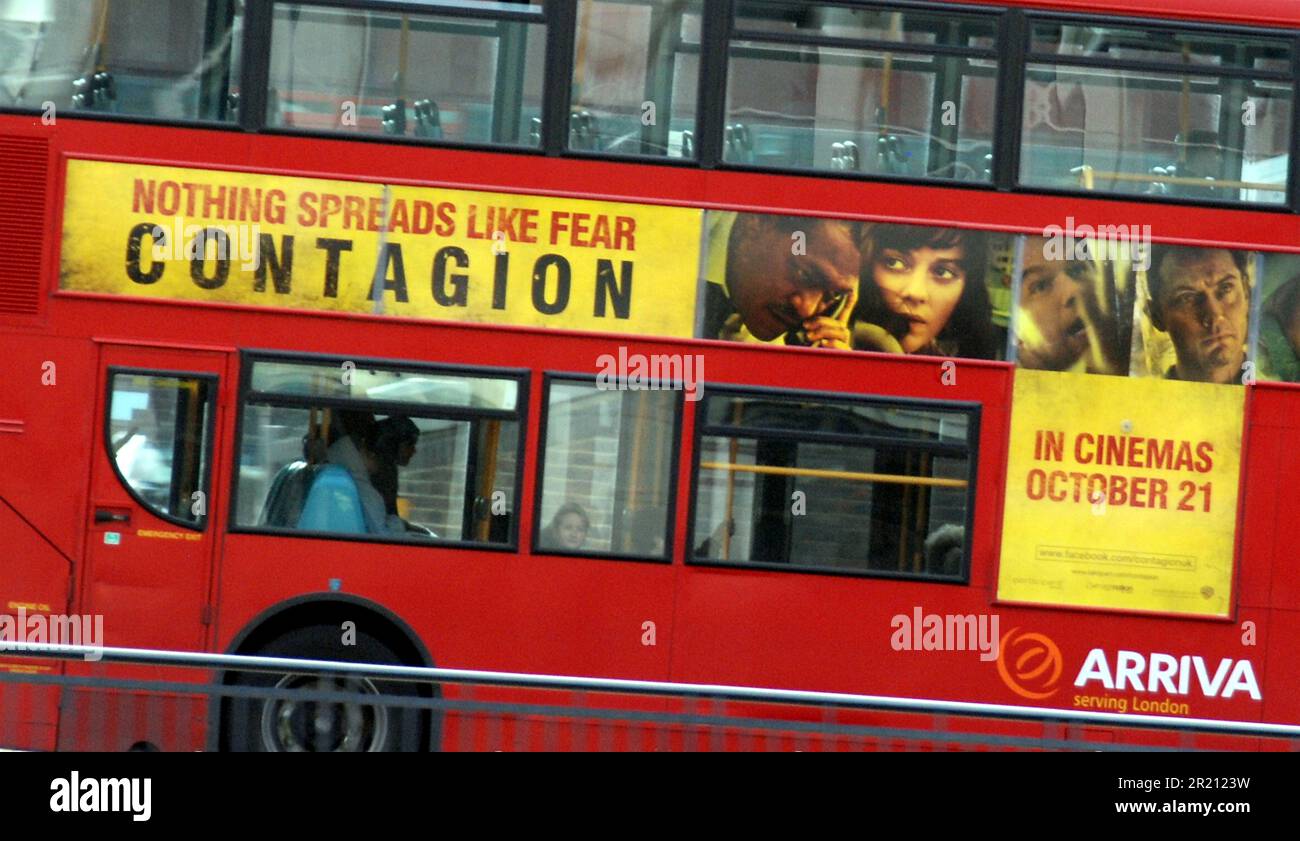 Photograph of a London bus advertising the film Contagion. Its plot focused on the spread of a virus and attempts by medical researchers and public health officials to identify and contain the disease, the loss of social order in a pandemic, and finally the introduction of a vaccine to halt its spread. The film has been described as closely resembling the spread of the coronavirus COVID-19 which began in China and fanned out across the globe in 2020. Stock Photo