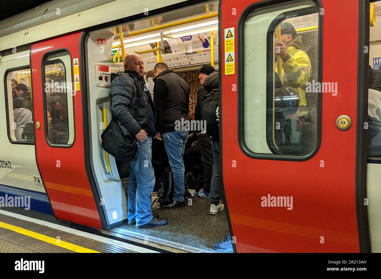 Photograph of an overcrowded London Underground train on which passengers were unable to observe social distancing of at least 2 metres just days after the UK government ordered pubs, clubs, restaurants, bars and gyms to shut as the concern over the COVID-19 coronavirus pandemic grew Stock Photo