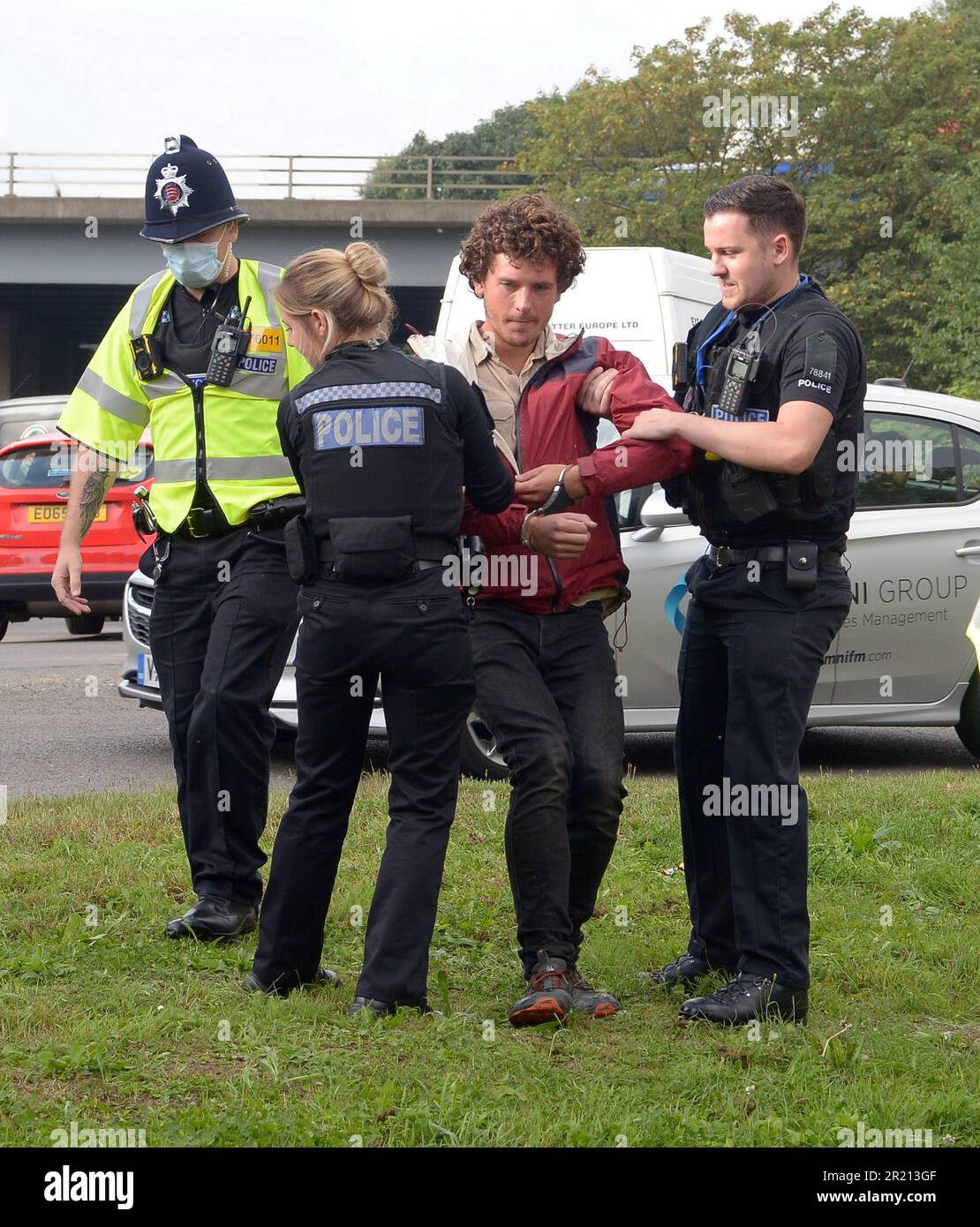Police arrest climate change protesters who attempted to block the M25 at junction 28 near Brentwood, Essex as they demand government action on home insulation. More than 100 people were arrested in three days of protests. Protest group Insulate Britain said action would go on until a 'meaningful commitment' was made. September, 2021. Stock Photo