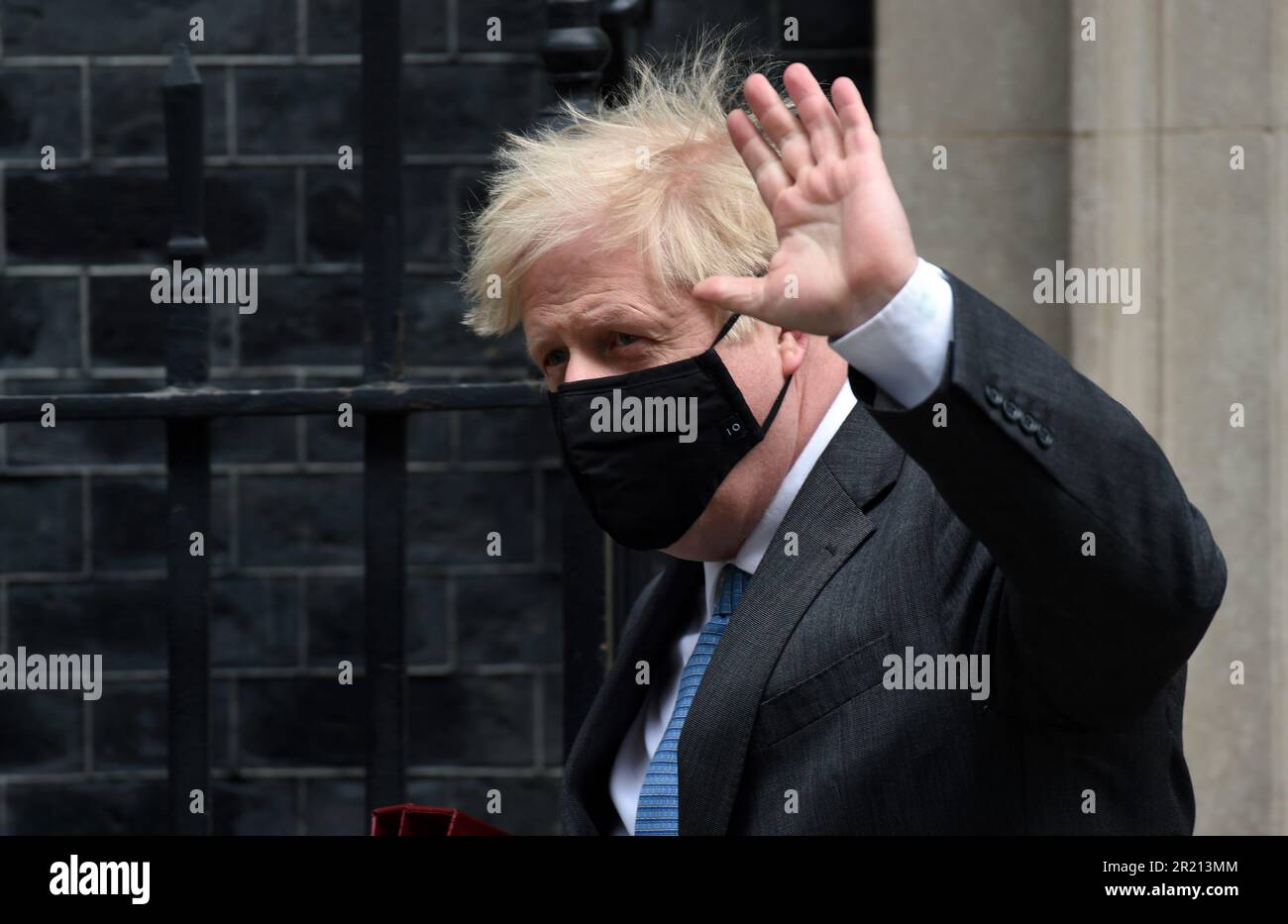 Boris Johnson leaves No.10 Downing Street for PMQs amid the COVID-19 coronavirus pandemic and in a week that he faced a string of serious allegations from financial issues concerning flat refurbishment to reports that he resisted a second lockdown in October 2020 saying, 'No more f***ing lockdowns - let the bodies pile high in their thousands!' April, 2021. Stock Photo