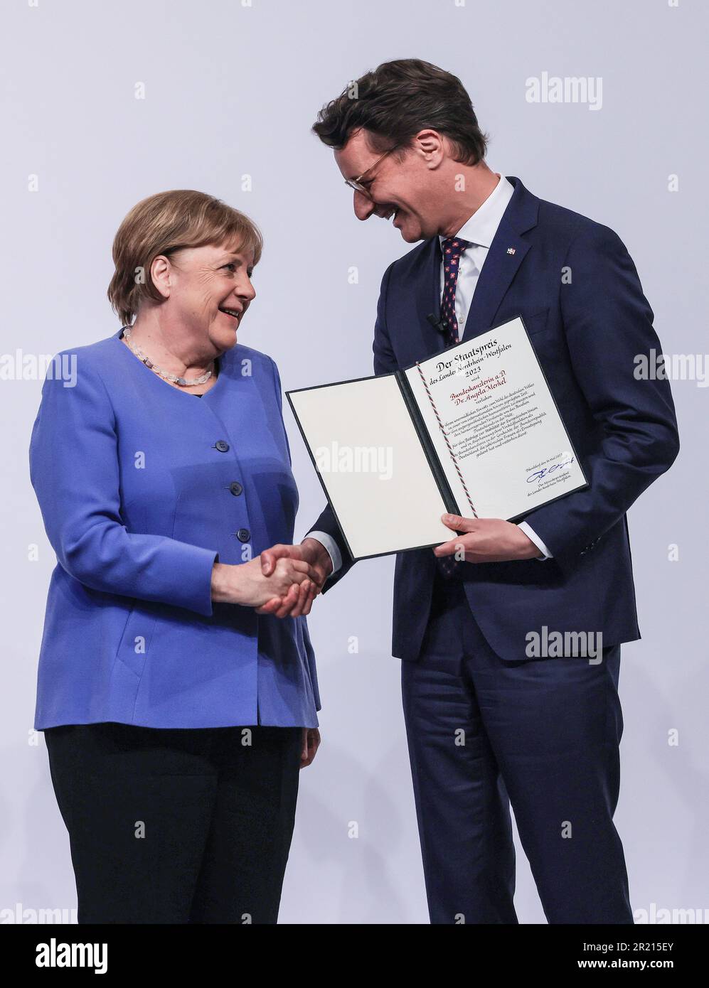 Cologne, Germany. 16th May, 2023. Former Chancellor Angela Merkel (l, CDU) accepts the state award from Hendrik Wüst (r, CDU), Minister President of North Rhine-Westphalia. Credit: Oliver Berg/dpa/Alamy Live News Stock Photo