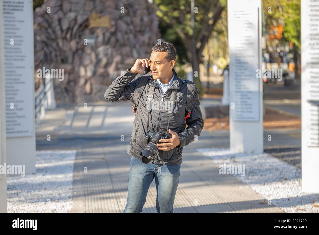 Young latin man talking on mobile phone with copy space. Stock Photo