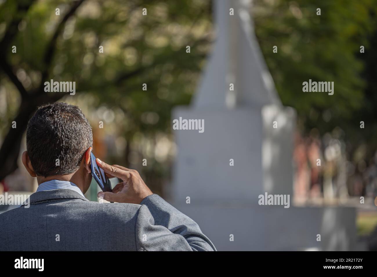 Young latino man talking on the mobile phone with copy space. Stock Photo