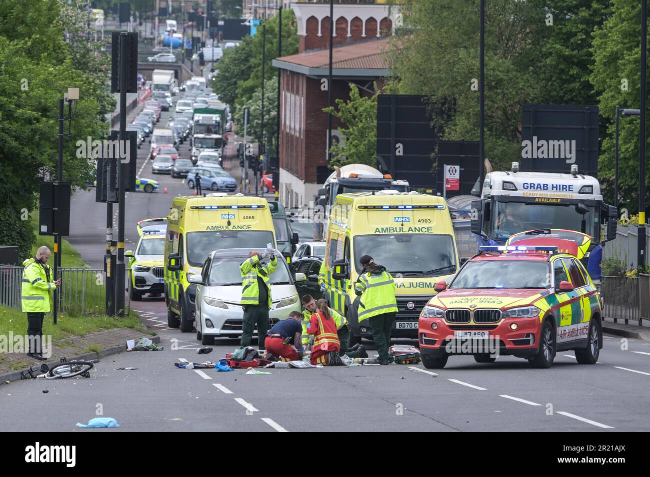 Belgrave Middleway, Birmingham, 16th May 2023 - Emergency Services try in vain to save the cyclist. - A man has died after he was hit by a vehicle whilst crossing a major road through Birmingham city centre on Tuesday afternoon. Paramedics worked on the cyclist but he was declared dead at the scene. West Midlands Police closed both sides of Belgrave Middleway which is a 3-lane ring road through the city centre, causing traffic gridlock as officers investigate the mans death. The white vehicle is believed to be a witness and not involved in the RTC. West Midlands Police said at the time: 'We ar Stock Photo