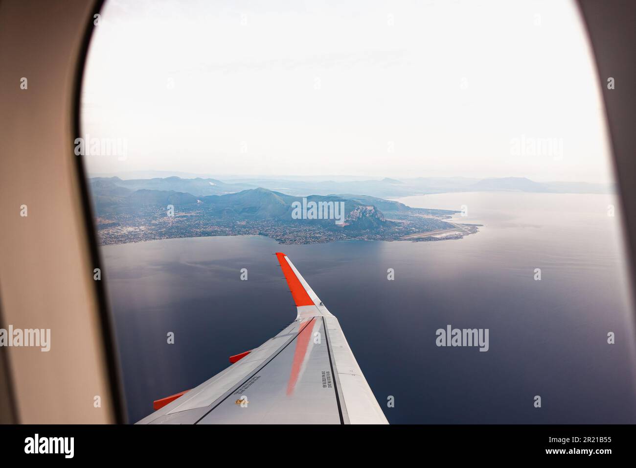 Aerial view of Sicily from the window of an airplane that took off from Palermo,  Punta Raisi airport. Aerial view of the Sicilian sea and coast. Stock Photo
