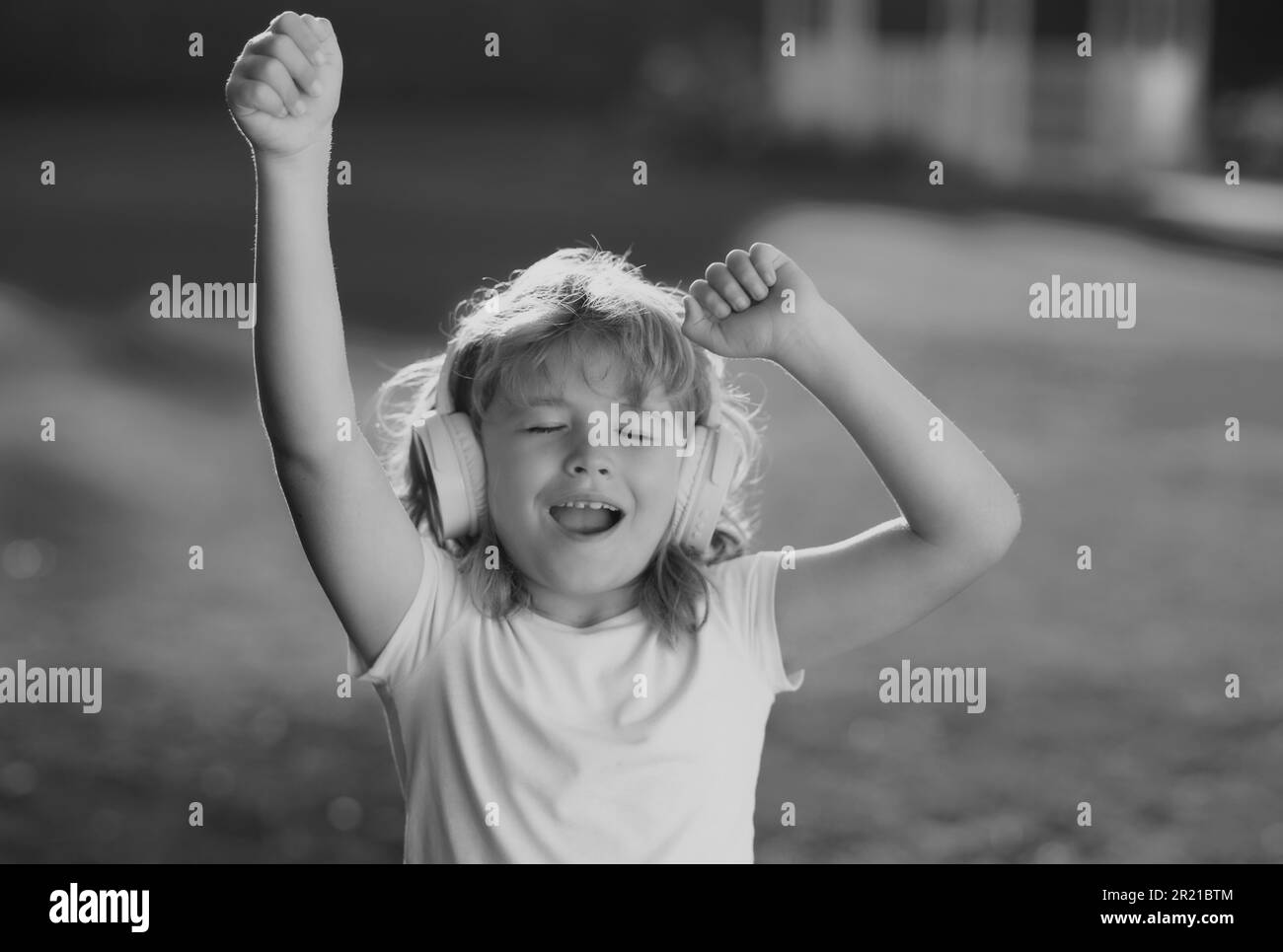 Singing and dancing children. Happy child enjoys listens to music in