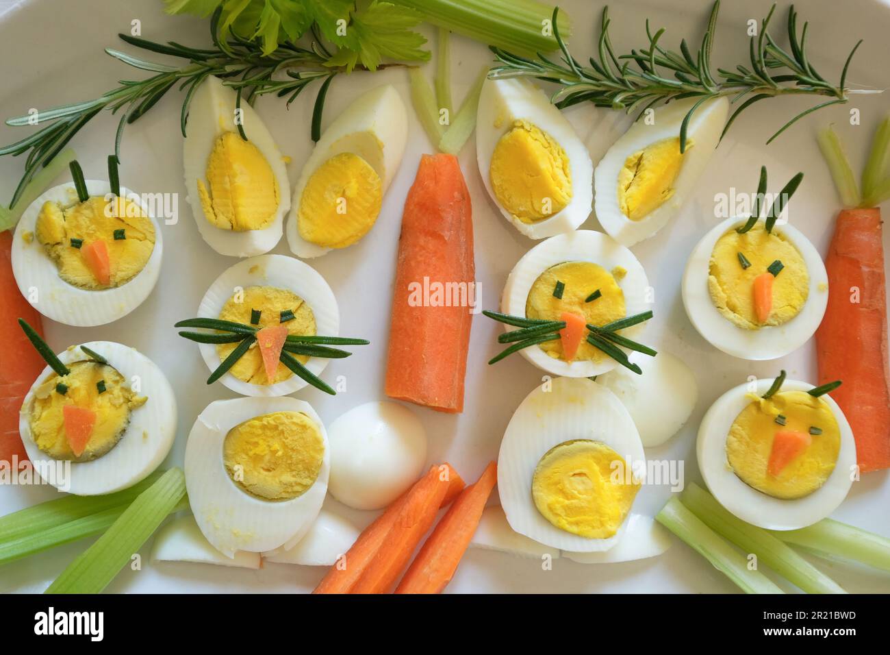 Easter appetizer of boiled eggs in the form with bunny face and carrots