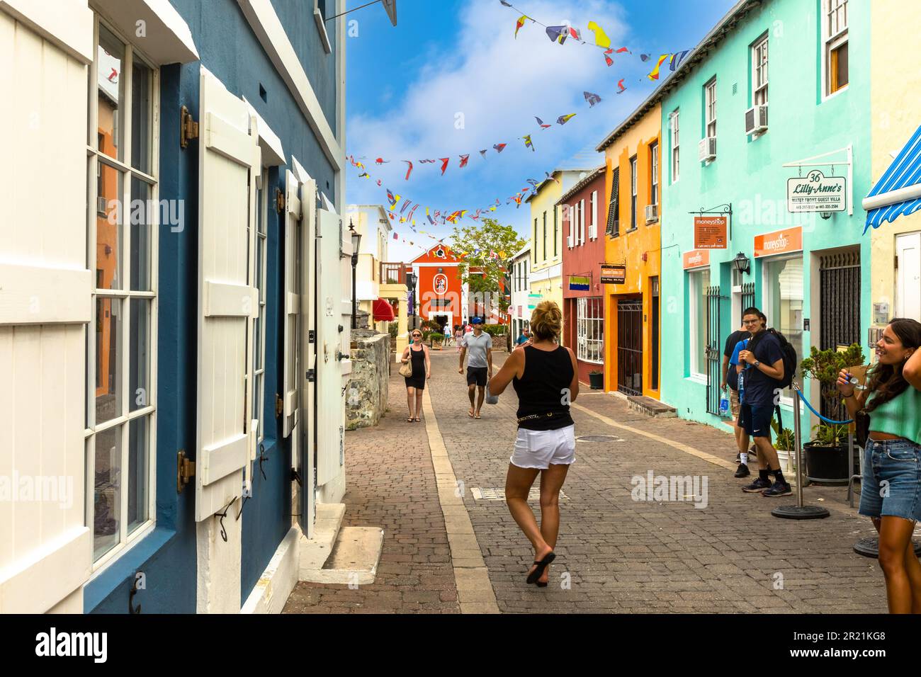 Visitors stroll a main shopping street in St. George, Bermuda Stock Photo
