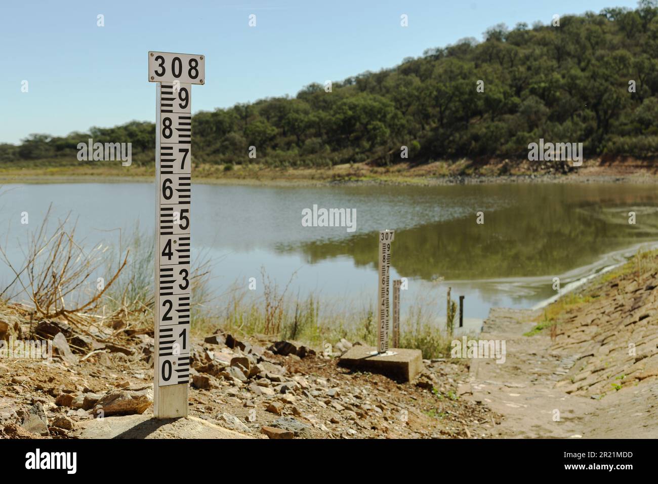 The water level meter of this dam demonstrates the scarcity of water that exists due to the lack of rain, there is drought and lack of water. Stock Photo